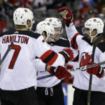 New Jersey Devils defenseman Jonas Siegenthaler, right, celebrates with teammates after scoring a goal against the Philadelphia Flyers during the second period of an NHL hockey game Saturday, Feb. 25, 2023, in Newark, N.J. (AP Photo/Adam Hunger)