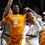 Tennessee forward Tobe Awaka (11) and Vanderbilt forward Myles Stute (10) vie for possession of the ball during the first half of an NCAA college basketball game Wednesday, Feb. 8, 2023, in Nashville, Tenn. (AP Photo/Wade Payne)