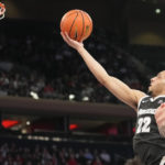 
              Providence guard Devin Carter (22) shoots the ball during the first half of an NCAA college basketball game against St. John's, Saturday, Feb. 11, 2023m in New York. (AP Photo/Bryan Woolston)
            
