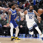Minnesota Timberwolves guard Mike Conley (10) attempts to get around Dallas Mavericks' Kyrie Irving (2) and Dwight Powell, left, in the first half of an NBA basketball game, Monday, Feb. 13, 2023, in Dallas. (AP Photo/Tony Gutierrez)