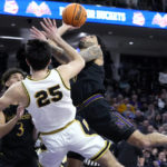 Northwestern guard Boo Buie, right, drives to the basket against Purdue guard Ethan Morton during the second half of an NCAA college basketball game in Evanston, Ill., Sunday, Feb. 12, 2023. (AP Photo/Nam Y. Huh)