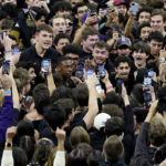 Northwestern guard Chase Audige, center, celebrates with fans after defeating Purdue in an NCAA college basketball game in Evanston, Ill., Sunday, Feb. 12, 2023. (AP Photo/Nam Y. Huh)