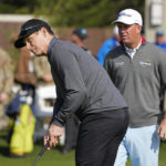 
              Steve Young, left, and Tom Hoge compete in the putting challenge event of the AT&T Pebble Beach Pro-Am golf tournament in Pebble Beach, Calif., Wednesday, Feb. 1, 2023. (AP Photo/Eric Risberg)
            