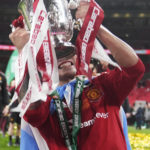 
              Manchester United's Lisandro Martinez celebrates with the trophy after the English League Cup final soccer match between Manchester United and Newcastle United at Wembley Stadium in London, Sunday, Feb. 26, 2023. (AP Photo/Alastair Grant)
            