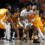 Vanderbilt forward Colin Smith collides with Tennessee guard Zakai Zeigler, right, as he drives to the basket during the first half of an NCAA college basketball game Wednesday, Feb. 8, 2023, in Nashville, Tenn. (AP Photo/Wade Payne)