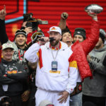 
              Kansas City Chiefs tight end Travis Kelce, center, is cheered on by Patrick Mahomes, back right, while giving a speech during the Chiefs' victory celebration and parade in Kansas City, Mo., Wednesday, Feb. 15, 2023. The Chiefs defeated the Philadelphia Eagles Sunday in the NFL Super Bowl 57 football game. (AP Photo/Reed Hoffmann)
            