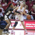 Indiana's Grace Berger (34) is fouled by Purdue's Jayla Smith (3) during the first half of an NCAA college basketball game, Sunday, Feb. 19, 2023, in Bloomington, Ind. (AP Photo/Darron Cummings)