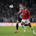 Newcastle's Paul Dummett, left, and Manchester United's Marcus Rashford challenge for the ball during the English League Cup final soccer match between Manchester United and Newcastle United at Wembley Stadium in London, Sunday, Feb. 26, 2023. (AP Photo/Alastair Grant)