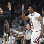 South Carolina forward Gregory Jackson II (23) high fives head coach Lamont Paris, left, during the first half of an NCAA college basketball game against Alabama Wednesday, Feb. 22, 2022, in Columbia, S.C. (AP Photo/Sean Rayford)
