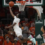 
              Miami guard Wooga Poplar (55) drives to the basket during the first half of an NCAA college basketball game against Florida State , Saturday, Feb. 25, 2023, in Coral Gables, Fla. (AP Photo/Marta Lavandier)
            