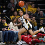 Iowa guard Gabbie Marshall (24) fights for a loose ball with Maryland guard Shyanne Sellers (0) during the second half of an NCAA college basketball game, Thursday, Feb. 2, 2023, in Iowa City, Iowa. (AP Photo/Charlie Neibergall)