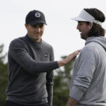 Jordan Spieth, left, greets playing partner Jake Owen on the first green of the Spyglass Hill Golf Course during the AT&T Pebble Beach Pro-Am golf tournament in Pebble Beach, Calif., Thursday, Feb. 2, 2023. (AP Photo/Godofredo A. Vásquez)
