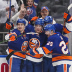 New York Islanders center Bo Horvat (14) celebrates with teammates Sebastian Aho (25) and Mathew Barzal (13) after scoring a goal during the second period of an NHL hockey game against the Seattle Kraken Tuesday, Feb. 7, 2023, in Elmont, N.Y. (AP Photo/Frank Franklin II)