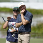 
              Chris Kirk, right, talks with his caddie Michael Cromie, left, on the 17th green during the second round of the Honda Classic golf tournament, Friday, Feb. 24, 2023, in Palm Beach Gardens, Fla. (AP Photo/Lynne Sladky)
            