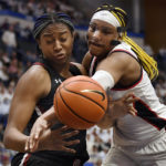 UConn's Aaliyah Edwards knocks the ball from South Carolina's Aliyah Boston, left, in the first half of an NCAA college basketball game, Sunday, Feb. 5, 2023, in Hartford, Conn. (AP Photo/Jessica Hill)