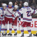 
              New York Rangers' Braden Schneider, Niko Mikkola, Artemi Panarin, Jimmy Vesey and Vincent Trocheck, from left, celebrate Mikkola's goal against the Vancouver Canucks during the first period of an NHL hockey game Wednesday, Feb. 15, 2023, in Vancouver, British Columbia. (Darryl Dyck/The Canadian Press via AP)
            