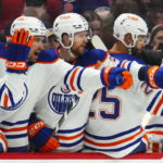 
              Edmonton Oilers left wing Zach Hyman (18) celebrates a goal with teammates on the bench during the second period of an NHL hockey game against the Ottawa Senators in Ottawa on Saturday, Feb. 11, 2023. (Sean Kilpatrick/The Canadian Press via AP)
            