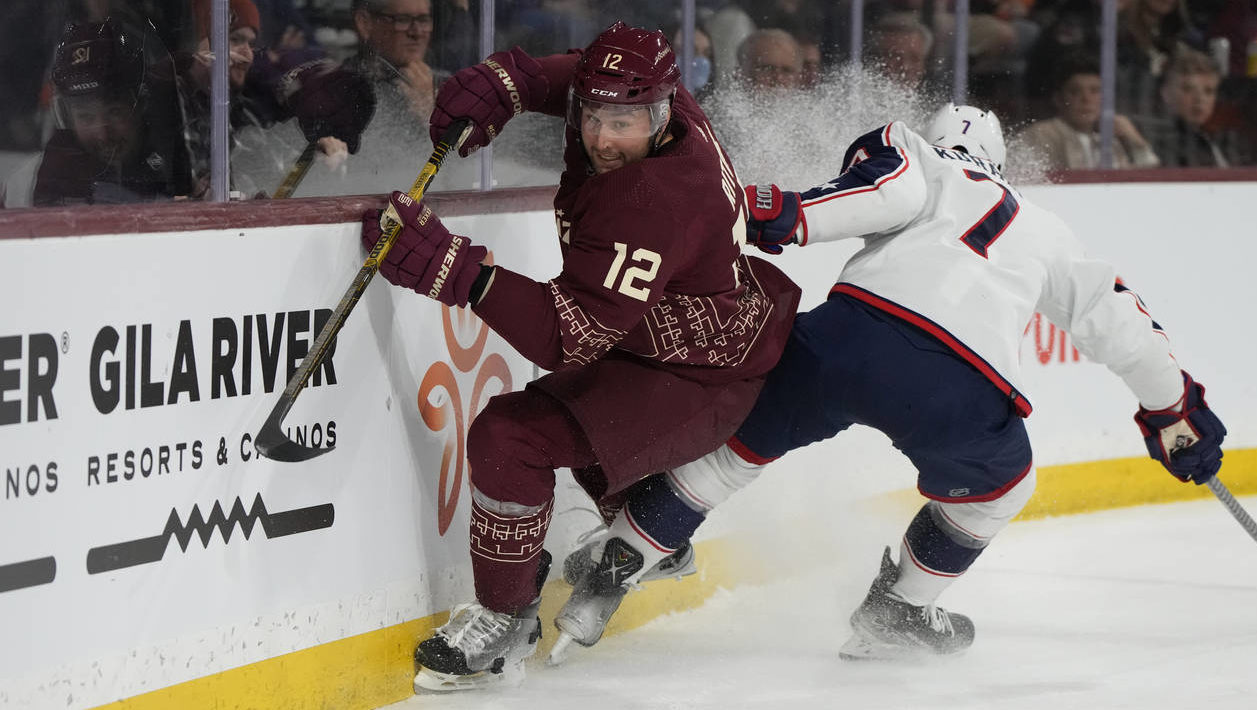 Arizona Coyotes left wing Nick Ritchie (12) avoids the check from Columbus Blue Jackets center Sean...