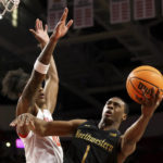 Northwestern guard Chase Audige (1) shoots past Maryland forward Julian Reese (10) during the first half of an NCAA college basketball game, Sunday, Feb. 26, 2023, in College Park, Md. (AP Photo/Julia Nikhinson)
