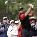 FILE -  Tiger Woods tees off on the 4th hole during the final round of the PNC Championship golf tournament Sunday, Dec. 18, 2022, in Orlando, Fla. Woods is back at Riviera, this time with more on his plate than handing out the trophy in the Genesis Invitational. He returns to the PGA Tour for the first time since July. (AP Photo/Kevin Kolczynski, File)