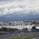 
              With snow-covered mountains in the distance, cars drive in a five-line formation to acknowledge the fans before a NASCAR Cup Series auto race at Auto Club Speedway in Fontana, Calif., Sunday, Feb. 26, 2023. The track hosts its final NASCAR Cup race Sunday. (AP Photo/Jae C. Hong)
            