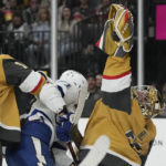 Vegas Golden Knights goaltender Adin Hill (33) catches the puck out of the air against Tampa Bay Lightning center Anthony Cirelli (71) during the first period of an NHL hockey game Saturday, Feb. 18, 2023, in Las Vegas. (AP Photo/John Locher)