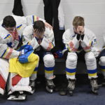 
              Ukraine hockey goalie Mati Kulish, left, consoles teammate Yehor Kosenko after losing their match against Vermont Flames Academy at the International Peewee Tournament in Quebec City, Friday, Feb. 17, 2023.  (Jacques Boissinot/The Canadian Press via AP)
            