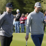
              Buster Posey, left, and Aaron Rodgers watch during the putting challenge event of the AT&T Pebble Beach Pro-Am golf tournament in Pebble Beach, Calif., Wednesday, Feb. 1, 2023. (AP Photo/Eric Risberg)
            
