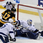 
              Pittsburgh Penguins right wing Bryan Rust (17) pressures Tampa Bay Lightning goalie Brian Elliott (1) during the first period of an NHL hockey game, Sunday, Feb. 26, 2023, in Pittsburgh. (AP Photo/Philip G. Pavely)
            