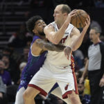 Charlotte Hornets center Nick Richards attempts to knock the ball away from Miami Heat center Cody Zeller during the first half of an NBA basketball game, Saturday, Feb. 25, 2023, in Charlotte, N.C. (AP Photo/Matt Kelley)