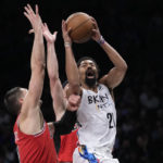 Brooklyn Nets guard Spencer Dinwiddie (26) goes to the basket against Chicago Bulls center Nikola Vucevic, left, during the first half of an NBA basketball game, Thursday, Feb. 9, 2023, in New York. (AP Photo/Mary Altaffer)