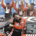 
              FILE - Tony Stewart is sprayed by teammates as he celebrates after winning the NASCAR Sirius Satellite Radio at the Glen at Watkins Glen International in Watkins Glen, N.Y., Sunday, Aug. 14, 2005. (AP Photo/David Duprey, FIle)
            