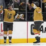 
              Vegas Golden Knights right wing Jonathan Marchessault, left, celebrates after scoring against the Tampa Bay Lightning during the first period of an NHL hockey game Saturday, Feb. 18, 2023, in Las Vegas. (AP Photo/John Locher)
            