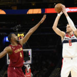 Washington Wizards center Kristaps Porzingis (6) looks to shoot against Cleveland Cavaliers forward Evan Mobley (4) during the first half of an NBA basketball game, Monday, Feb. 6, 2023, in Washington. (AP Photo/Nick Wass)