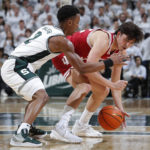 Michigan State's Tyson Walker, left, and Indiana's Trey Galloway vie for the ball during the first half of an NCAA college basketball game, Tuesday, Feb. 21, 2023, in East Lansing, Mich. (AP Photo/Al Goldis)