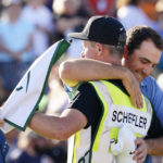 
              Scottie Scheffler, right, hugs his caddie Ted Scott after winning the Phoenix Open golf tournament, Sunday, Feb. 12, 2023, in Scottsdale, Ariz. (AP Photo/Darryl Webb)
            