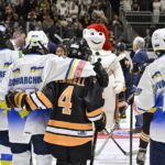 
              Ukraine and Boston Junior Bruins peewee team players stand together before a hockey game, Saturday, Feb, 11, 2023, in Quebec City.  From left, Maksym Kukharenko, Oleksii Bondarchuk, Patrick Fennell and Zahar Kovalenko.(Jacques Boissinot/The Canadian Press via AP)
            
