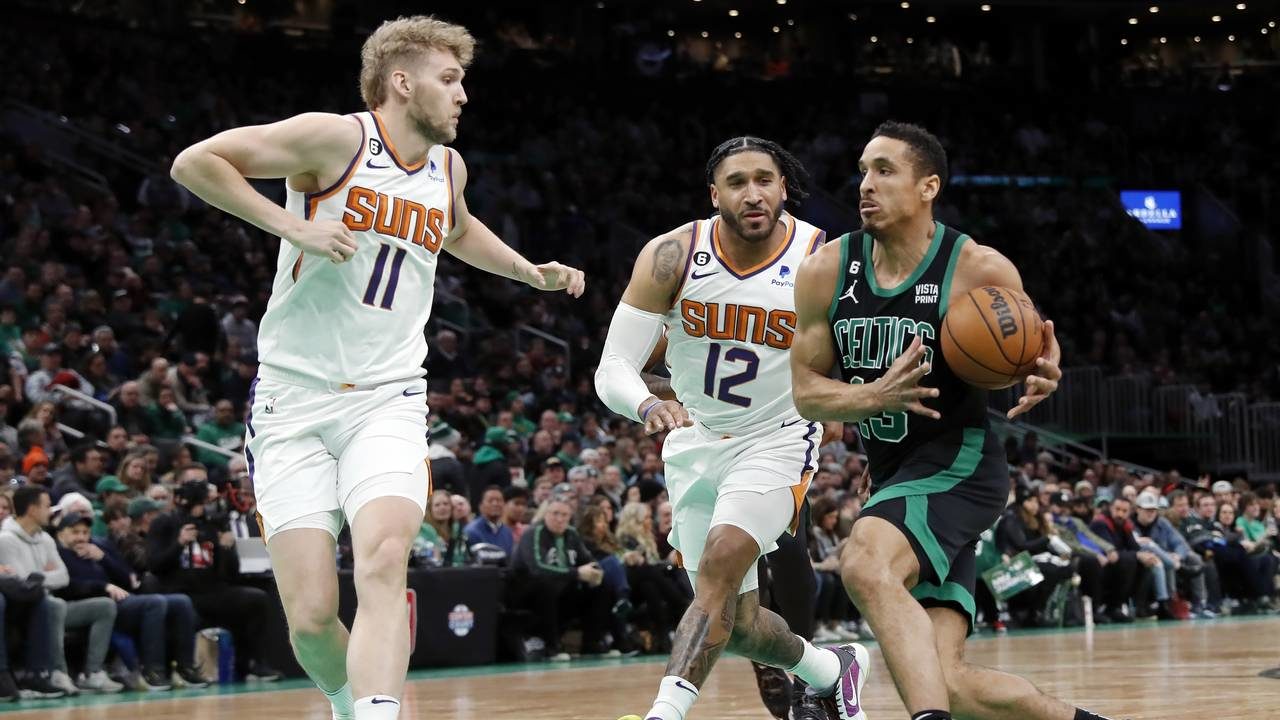 Boston Celtics' Malcolm Brogdon (13) drives for the basket against Phoenix Suns' Ish Wainright (12)...