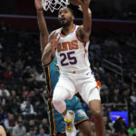 
              Phoenix Suns forward Mikal Bridges (25) drives on Detroit Pistons guard Alec Burks (5) in the first half of an NBA basketball game in Detroit, Saturday, Feb. 4, 2023. (AP Photo/Paul Sancya)
            