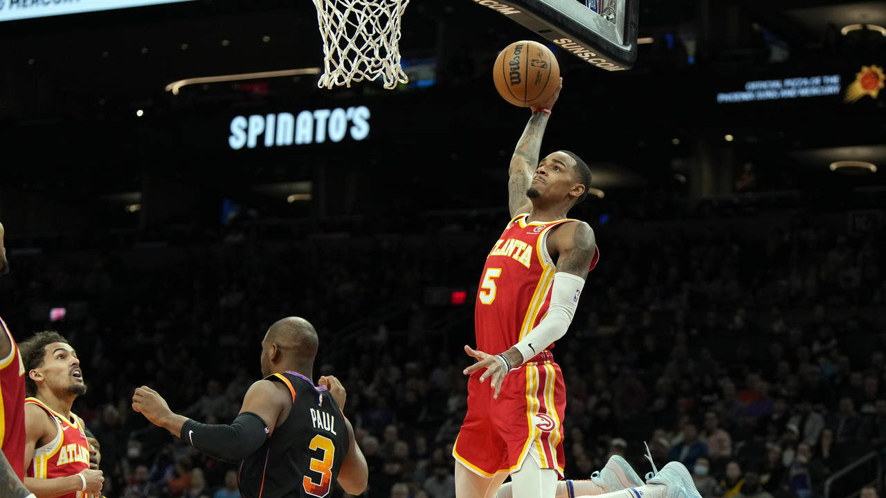 Atlanta Hawks guard Dejounte Murray (5) dunks over Phoenix Suns guard Chris Paul during the first h...