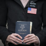 
              Sister Palmer, 19, holds The Book of Mormon while walking around Temple Square in Salt Lake City, on Nov. 15, 2020. Palmer, a member of The Church of Jesus Christ of Latter-day Saints, is serving an 18-month mission in Salt Lake City while waiting for her visa to continue the mission in Spain. Salt Lake City's hosting of this weekend's NBA All-Star game for the first time in three decades gives Utah another opportunity to reshape a long-held belief that the state is odd or peculiar — a years-long push that Utah Jazz owner Ryan Smith and many other influential state leaders have prioritized. (AP Photo/Wong Maye-E, File)
            
