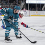 San Jose Sharks defenseman Jacob MacDonald, left, moves the puck while defended by Montreal Canadiens left wing Michael Pezzetta, background, during the second period of an NHL hockey game in San Jose, Calif., Tuesday, Feb. 28, 2023. (AP Photo/Godofredo A. Vásquez)