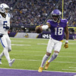 
              FILE - Minnesota Vikings wide receiver Justin Jefferson (18) scores on an 8-yard touchdown reception next to Indianapolis Colts cornerback Stephon Gilmore (5) during the second half of an NFL football game Dec. 17, 2022, in Minneapolis. Jalen Hurts, Jefferson and Patrick Mahomes are finalists for The Associated Press 2022 NFL Most Valuable Player and Offensive Player of the Year awards. (AP Photo/Andy Clayton-King, File)
            