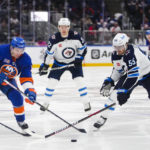 
              New York Islanders' Zach Parise (11) fights for control of the puck with Winnipeg Jets' Mark Scheifele (55) during the second period of an NHL hockey game Wednesday, Feb. 22, 2023, in Elmont, N.Y. (AP Photo/Frank Franklin II)
            