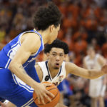 
              Duke's Tyrese Proctor (5) is defended by Virginia's Kihei Clark (0) during the second half of an NCAA college basketball game in Charlottesville, Va., Saturday, Feb. 11, 2023. (AP Photo/Mike Kropf)
            