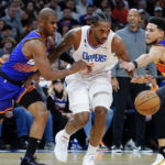 
              Phoenix Suns' Chris Paul, left, and Devin Booker, right, double-team Los Angeles Clippers' Kawhi Leonard during the first half of an NBA basketball game Thursday, Feb. 16, 2023, in Phoenix. (AP Photo/Darryl Webb)
            