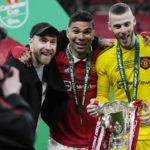 
              Manchester United's Casemiro, centre, Christian Eriksen, left, and goalkeeper David de Gea pose with the trophy after the English League Cup final soccer match between Manchester United and Newcastle United at Wembley Stadium in London, Sunday, Feb. 26, 2023. (AP Photo/Alastair Grant)
            