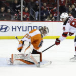 New Jersey Devils center Jack Hughes (86) scores a goal past Philadelphia Flyers goaltender Samuel Ersson during the second period of an NHL hockey game Saturday, Feb. 25, 2023, in Newark, N.J. (AP Photo/Adam Hunger)