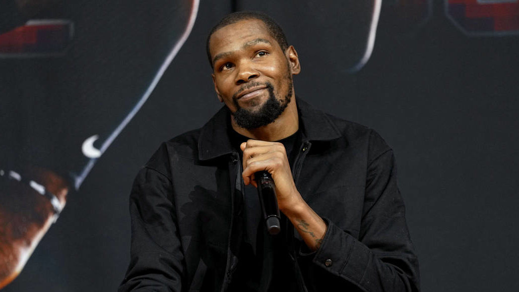 Phoenix Suns forward Kevin Durant, smiles after being introduced during an NBA basketball team avai...