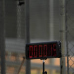 A pitch clock is seen off to the side as the Miami Marlins prepare for live batting practice during spring training baseball practice Sunday, Feb. 19, 2023, in Jupiter, Fla. (AP Photo/Jeff Roberson)